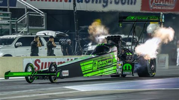 Pro Racer Leah Pruett In Driving Gear Says “Happy Hemi Day”